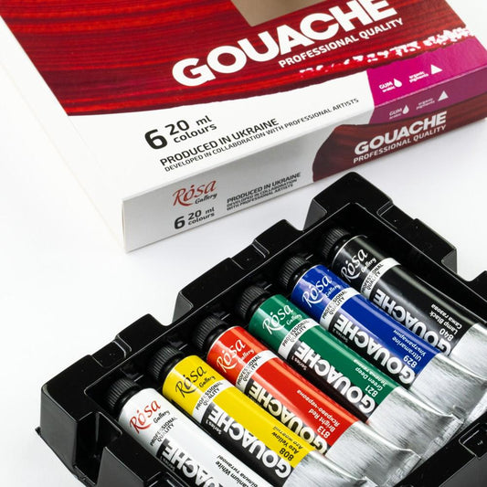 Set of Gouache paint tubes in various colors with packaging in the background.